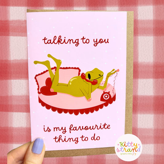Card with a cartoon frog on a pink couch and text 'talking to you is my favourite thing to do' on a red and white checkered background.