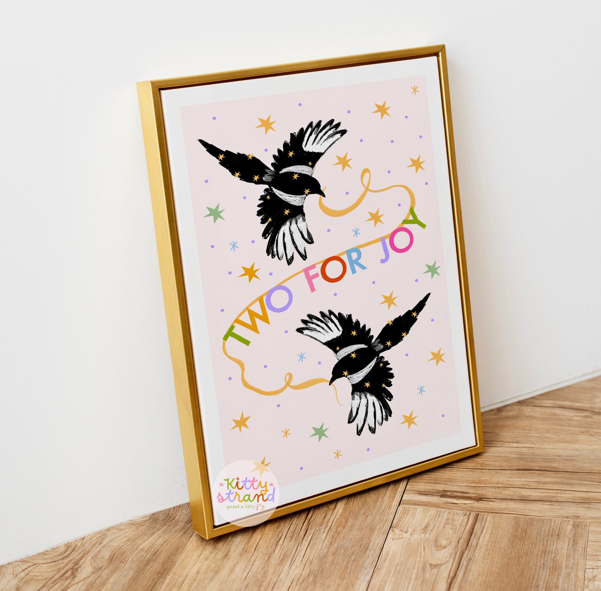 Framed artwork with magpie birds and colorful text on a light background