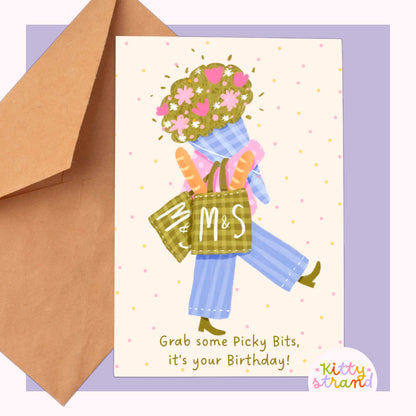Greeting card with a person holding flowers and a basket labeled 'M&S' next to a brown envelope.