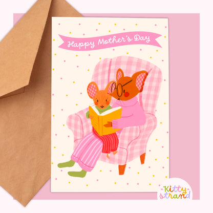 Sweet Mother's day card with an illustration of a mother mouse and baby mouse reading a book together in a gingham armchair 