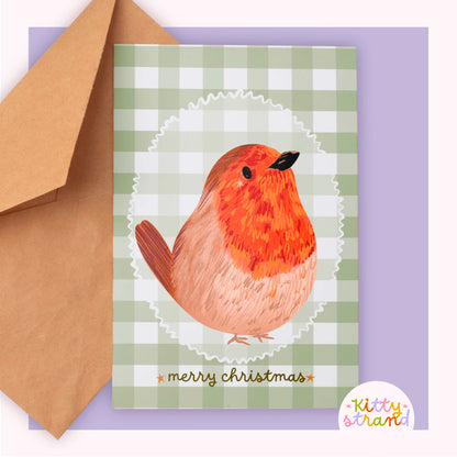 Greeting card with a robin design and 'merry christmas' text against a soft green gingham background 