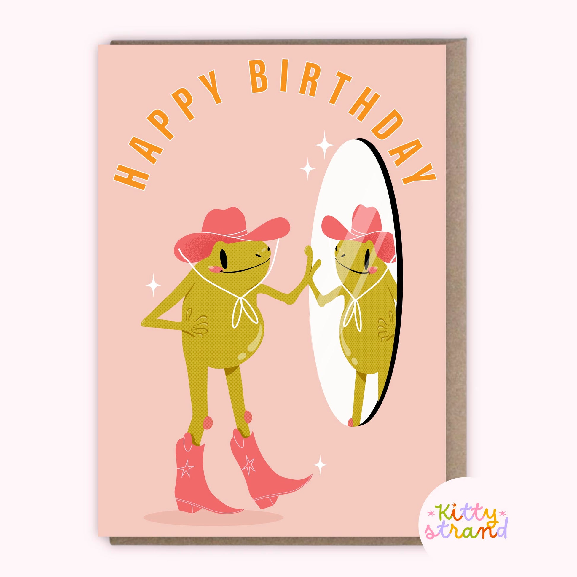 Birthday card with frogs in cowboy hats and boots on a pink background, featuring the brand 'Kitty Strand'.