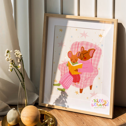 wall art with an illustration of two mice reading a book in a checkered chair with a pink background. Children's book inspired wall decor