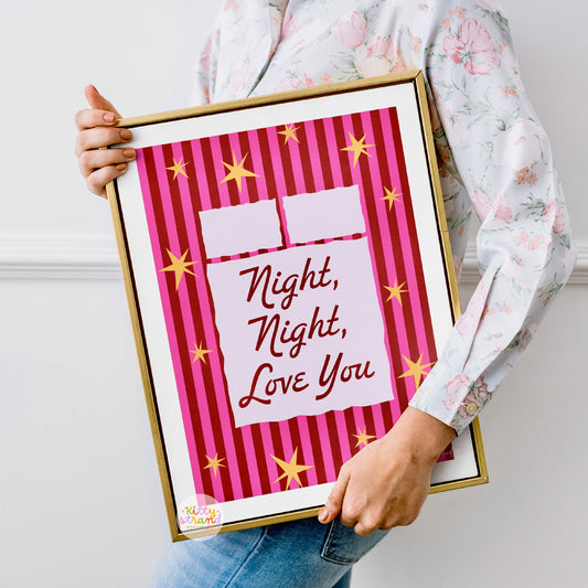 Person holding a framed print with 'Night, Night, Love You' text on a pink background.