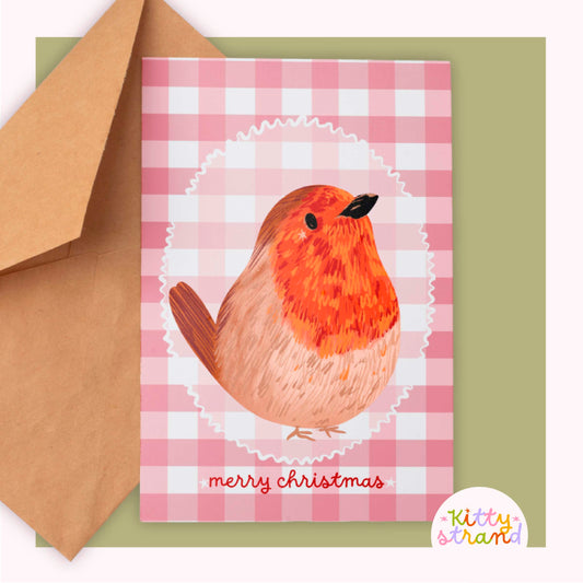 Greeting card with a robin design and 'merry christmas' text against a soft red gingham background 