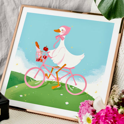 Framed illustration of a duck riding a pink bicycle with flowers and a basket.