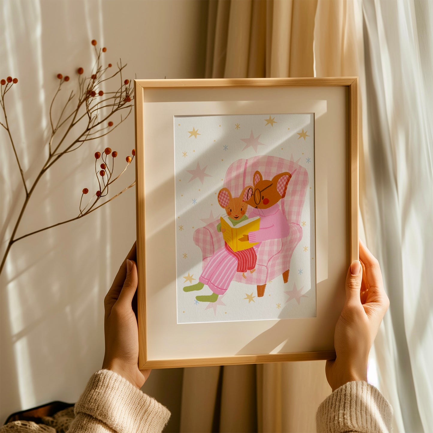 wall art with an illustration of two mice reading a book in a checkered chair with a pink background. Children's book inspired wall decor