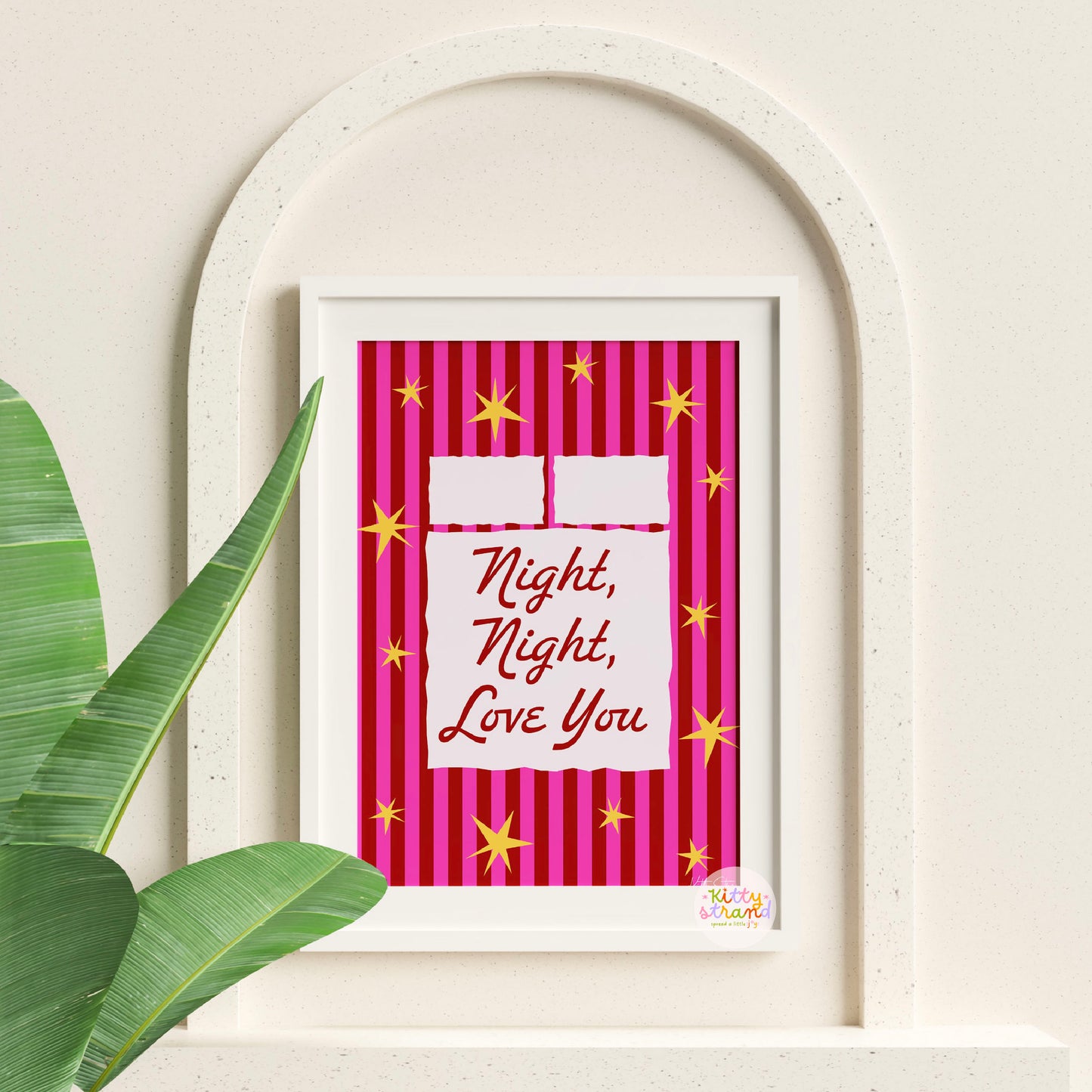 Framed artwork with 'Night, Night, Love You' text on a pink striped background, leaning against a white wall.