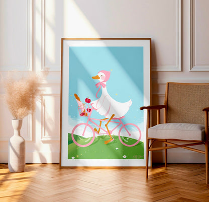 Framed artwork of a duck riding a bicycle with a basket indoors.